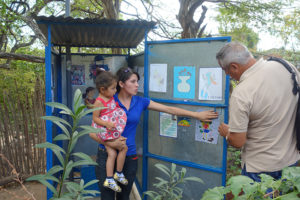 2015 - Woman shows Cezar of El Porvenir the artwork on her latrine