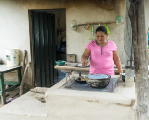 2015 - AMDV woman cooks on an improved stove
