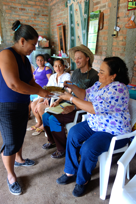 2014 - A woman in El Porton village offers Marcia Aviles of ODESAR food that she has learned to cook.